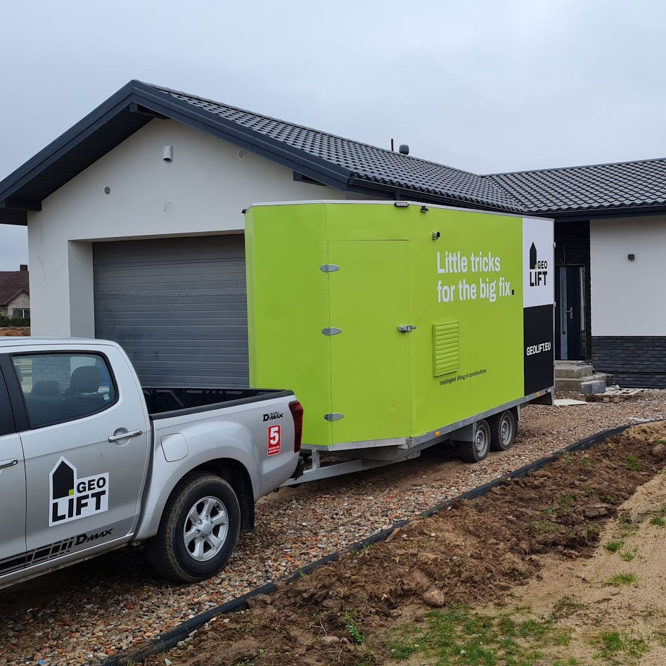 Geopolymer injection equipment setup for floor and foundation stabilization at a residential building