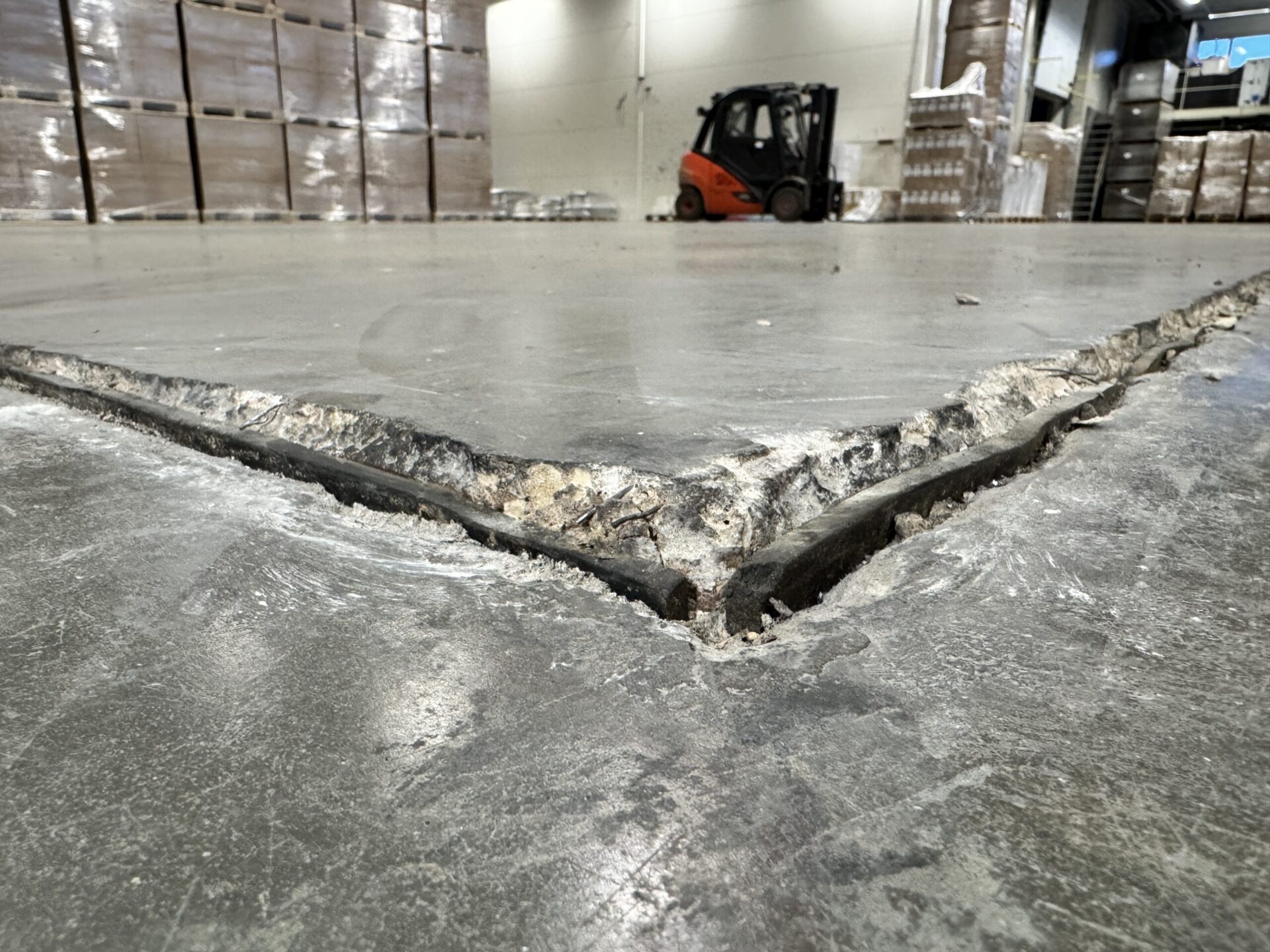 Cracked and uneven industrial concrete floor