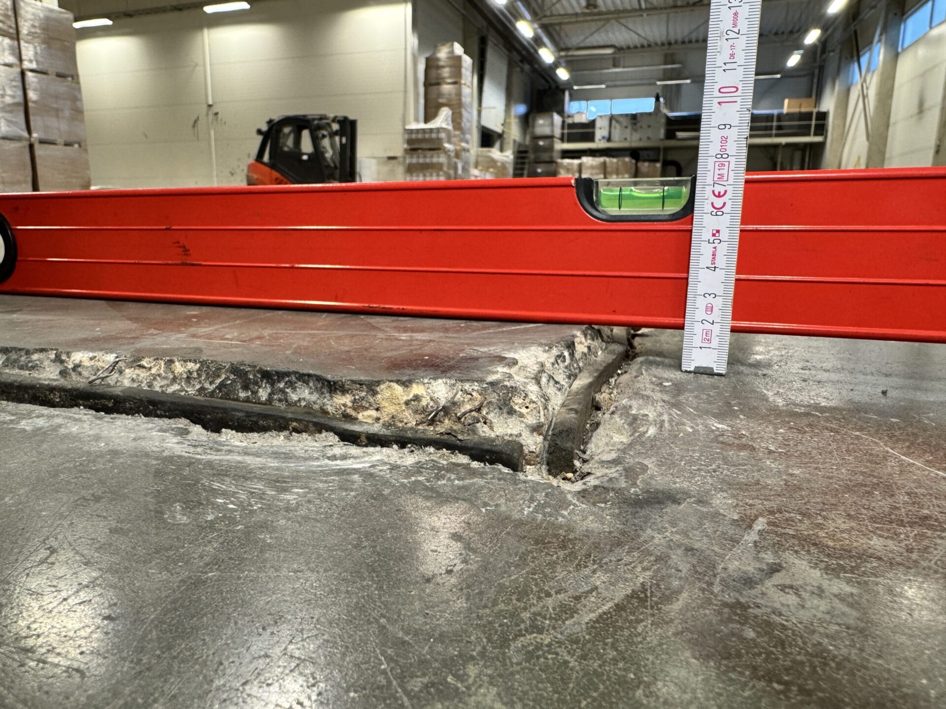 Industrial concrete floor damage revealing settlement caused by subsoil failure beneath the slab